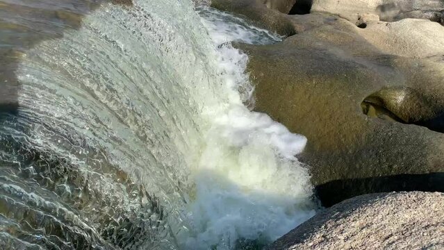 The view of the water in the dam during the dry season with its rocks is very beautiful