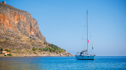 Travel, vacation, tourism in Greece concept- beautiful scenery with sea, mountain and sailing boat