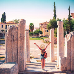 Ancient ruins of Agora- Roman Agora in Athens- happy woman tourist visiting famous touristic site...