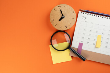 close up of calendar and alarm clock on the colorful table background, planning for business...