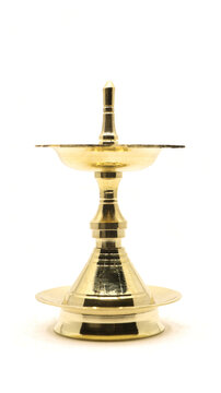 a vintage, brass oil lamp of unique traditional design used for temple celebration and festival rituals, also called as diya, vilakku or samai isolated