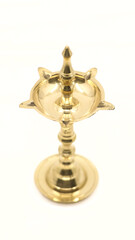 Fototapeta na wymiar a unique, antique oil wick lamp or diya or vilakku made of brass used for rituals and worship as a tradition in hindu culture isolated in a white background