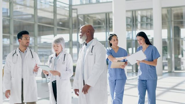Planning, consulting and tablet with doctors in hospital for meeting, advice and medical. Medicine, healthcare and research with group of people walking in clinic for teamwork, help and diversity