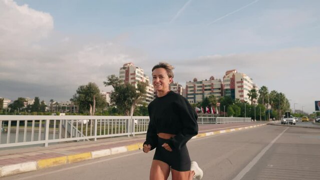Fitness healthy woman running on road at promenade. Jogging workout wellness concept. High quality 4k footage