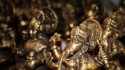 an antique idol of hindu god ganesha carved on stone in vintage gift shop for handcrafted statues and objects