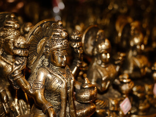 Fototapeta na wymiar closeup shot of a goddess laxmi devi idol carved in bronze in a religious antique souvenir shop