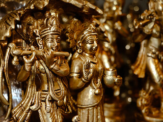 Fototapeta na wymiar closeup of hindu god lord krishna and radha sculpture in an antique store for vintage idols and gifts