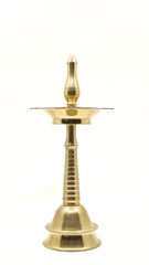 old vintage oil wick lamp or vilakku made of golden brass used in temples and places of worship traditionally isolated in a white background