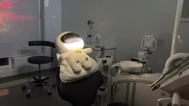 dental space office beautiful decor on wall light dark romance no one is empty soft toy sitting in a chair on a white pillow latest technology relaxation comfort