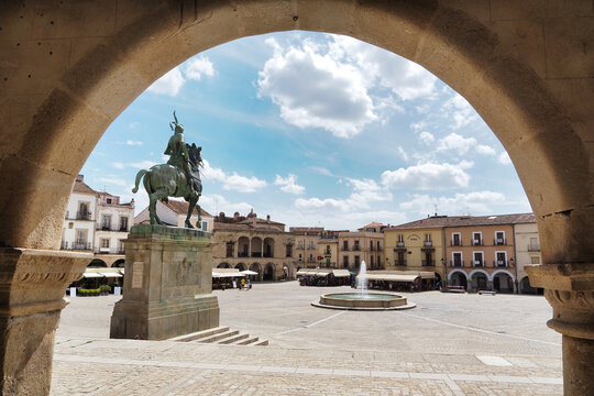 view of the main square of trujillo framed by an arch