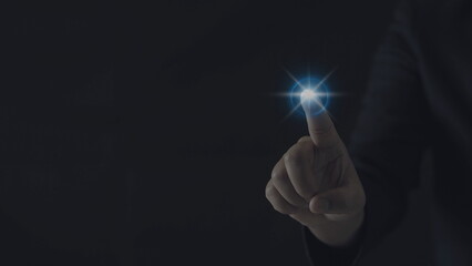 Businessman hand presses a glowing blue light. Concept of command with modern technology.