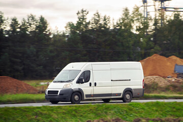 Fototapeta na wymiar Commercial van on the road. Delivery van close-up mockup isolated. Final destination shipping truck mock-up.
