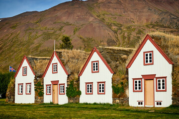 Icelandic folk buildings. A traditional white building with a grass roof