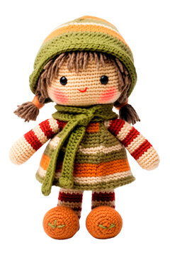 Knitted, soft, rag doll of a girl in a dress and a hat with a scarf. Isolated on a transparent background.