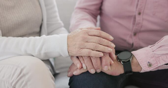 Closeup of senior couple holding hands for love, care and trust in retirement. Old man, woman and help with loyalty to partner in kindness, hope or support to forgive, with empathy for cancer at home