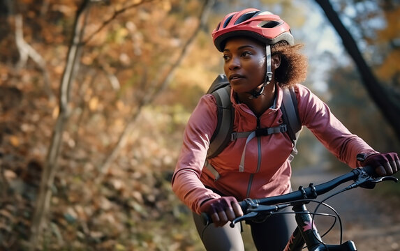 Afro teen, beautiful black skinned girl riding bike wearing a helmet outside.