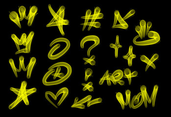 Collection of graffiti street art tags with words and symbols in yellow color on black background