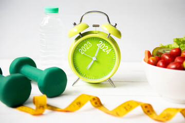 2024 and 2023 on alarm clock with workout planing for dieting. Sport exercise equipment workout...
