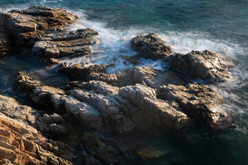 the sea crashing against the rocks