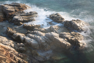 the sea crashing against the rocks