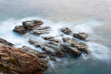 the sea crashing against the rocks