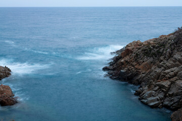 the sea crashing against the rocks
