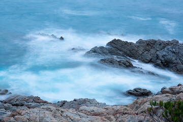 the sea crashing against the rocks