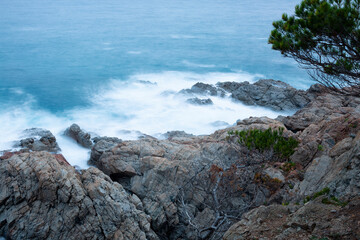 the sea crashing against the rocks