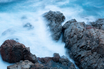 the sea crashing against the rocks