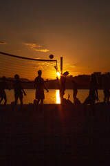 people play volleyball on the beach 