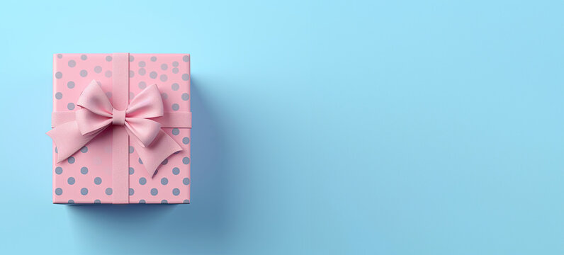 A picture of a gift box with pink ribbon on a blue background, in the style of light indigo and pink, blue polka dots.