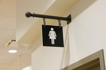 A woman washroom logo on the wall