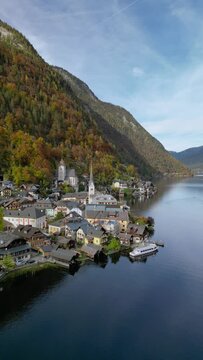 The drone aerial footage of Hallstatt in autumn, Austria. Hallstatt is a small town in the district of Gmunden, in the Austrian state of Upper Austria.