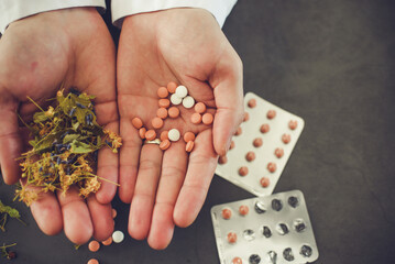 Medicine, pills and linden flowers in doctor's hands, natural medicine vs synthetic