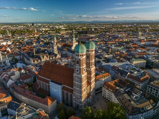 The drone aerial view of The Frauenkirche and downtown district of Munich, Germany. Munich Frauenkirche is one of the city's most famous landmarks. - obrazy, fototapety, plakaty
