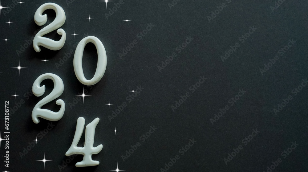 Wall mural close up white color of number 2024 shape on black color background with star glittering for happy n