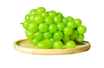 Bunches Shine Muscat grapes placed on wooden plate on transparent background. Closeup side view
