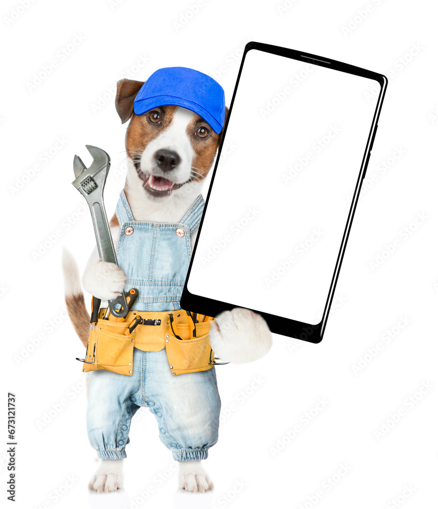 Poster funny puppy wearing denim overalls with tool belt holding adjustable wrench and showing big smartpho