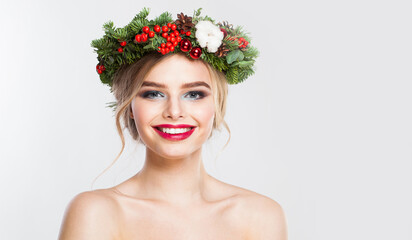 Naklejka premium Attractive blonde woman portrait. Fashion female model with blond curly hairstyle, make-up and green and red winter accessories posing on white background