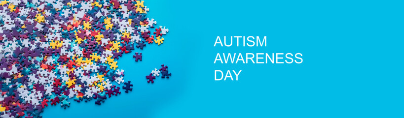 World autism awareness day banner.A bunch of colorful puzzles on a blue background of puzzles