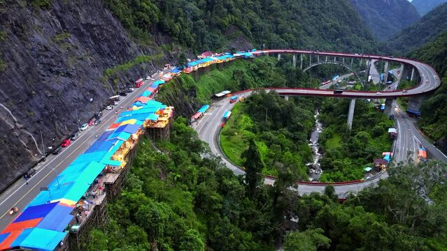 Aerial 4k video of Kelok 9 bridge at dusk. A popular bridge in Sumatra to commute between cities.