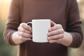 Close up of a man holding a large white coffee mug in his hand, mock up template for your design.