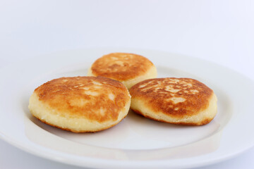 Delicious, sweet, ruddy cheesecakes on a white plate.
