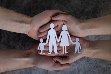 family and relationships, couple hands holding paper family with two children, care and protection...