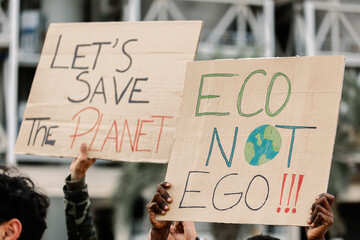 Group of activist people holding placards and banners for climate change. Environment and save the...