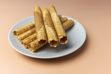 Fresh buttery waffle tubes on a plate