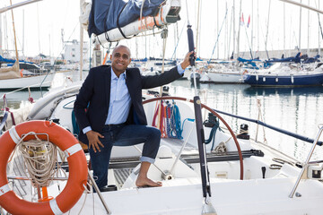 Man businessman on the yacht in the seaport