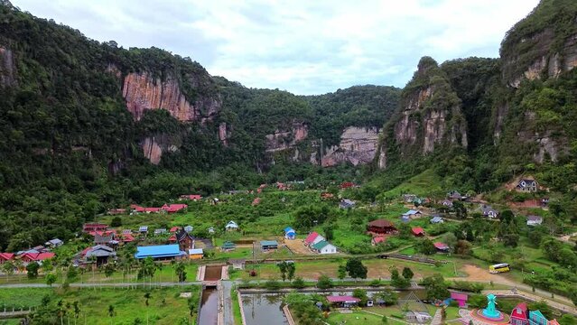 Aerial 4k video of Harau Valley, a popular tourist spot featuring mountains and rice fields at Sumatra island, Indonesia.