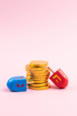 Jewish holiday Hanukkah concept. Traditional wooden dreidel - spinning top and chocolate coins gift.