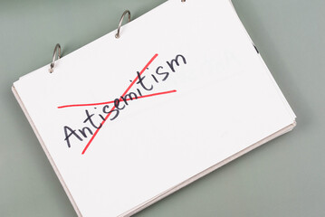 Antisemitism minimalistic concept. Crossed out with red lines Word Antisemitism written on white...